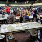 Photograph of Eugene Math Festival. Many festival goers are engaged in the many festival activities. Credit (https://blogs.uoregon.edu/mathfestival/)
